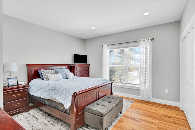 bedroom with hardwood / wood-style floors and a closet