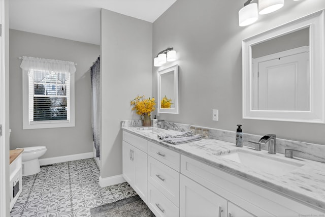 bathroom with tile patterned floors, vanity, and toilet