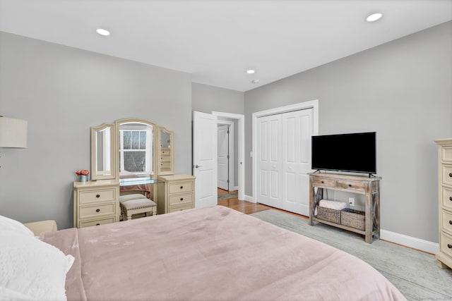 bedroom featuring light hardwood / wood-style floors and a closet