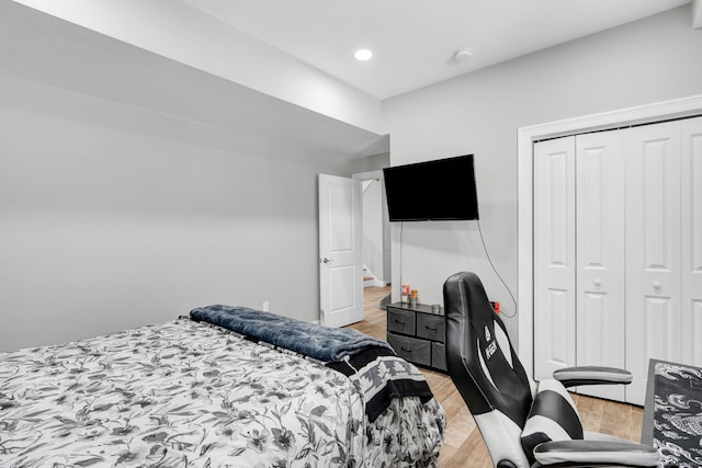 bedroom featuring light hardwood / wood-style floors and a closet