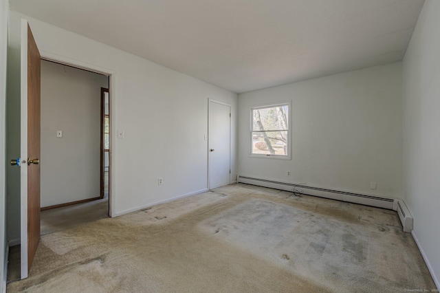 carpeted spare room with a baseboard radiator