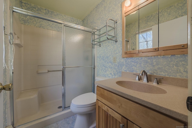 bathroom with vanity, toilet, and an enclosed shower