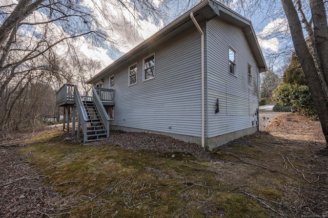 view of side of home with a wooden deck