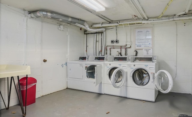 clothes washing area with washer and clothes dryer