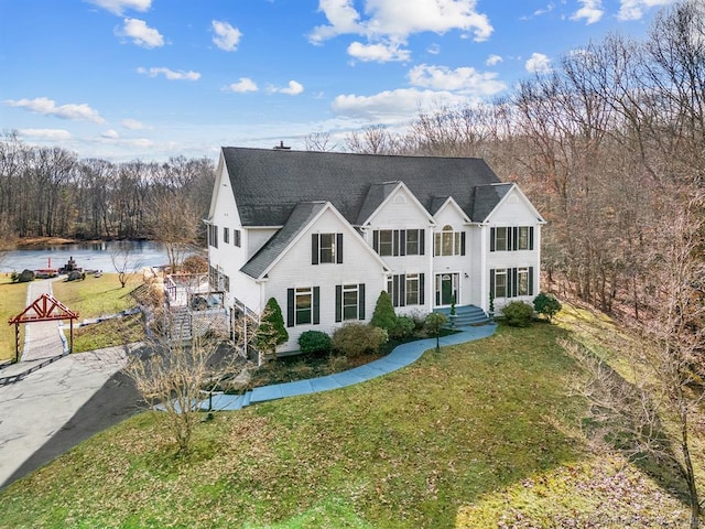 view of front of home with a water view and a front yard