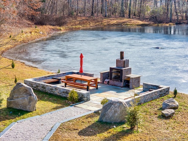 view of dock with a water view and a patio