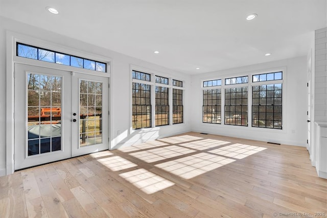 unfurnished sunroom featuring french doors