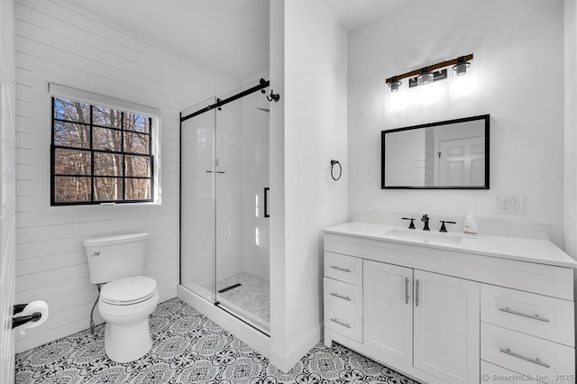 bathroom with tile patterned floors, vanity, toilet, and an enclosed shower