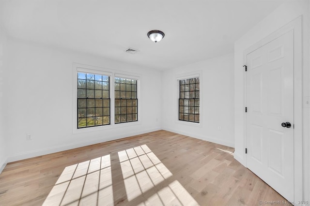 empty room with light hardwood / wood-style floors