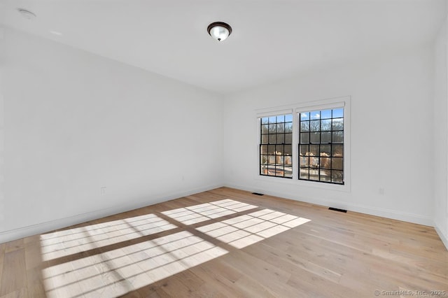 unfurnished room with light hardwood / wood-style flooring