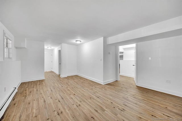 interior space with a baseboard radiator and light wood-type flooring