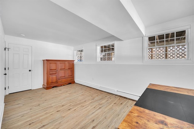 interior space with baseboard heating and light wood-type flooring