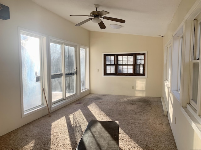 carpeted spare room with ceiling fan