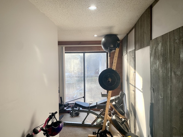 exercise room with a textured ceiling