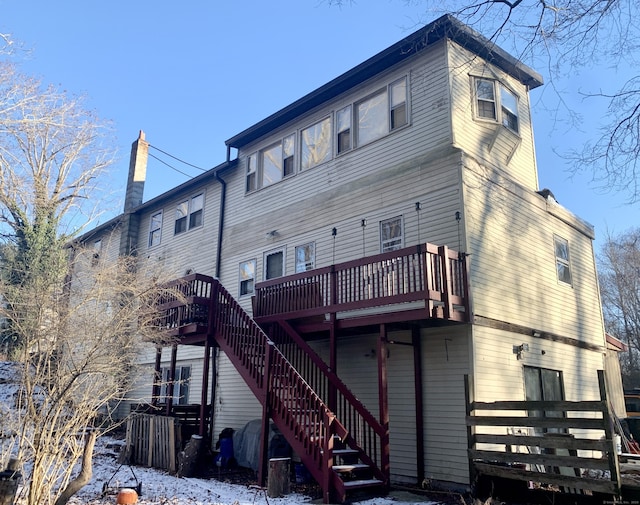 rear view of house featuring a wooden deck