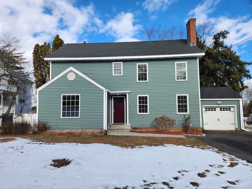 colonial inspired home featuring a garage