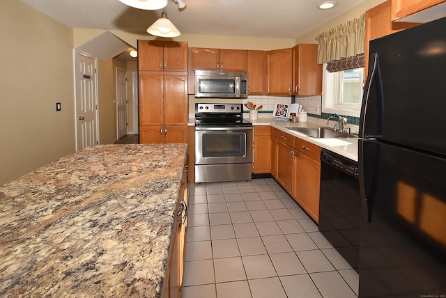 kitchen featuring black appliances, light countertops, a sink, and light tile patterned flooring