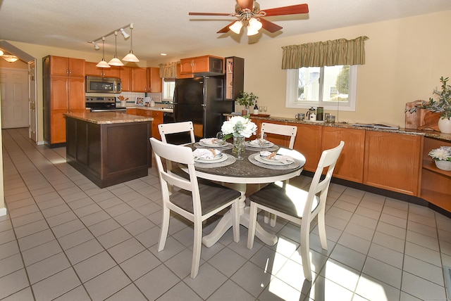 dining room with light tile patterned floors and ceiling fan