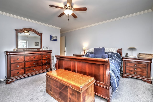 carpeted bedroom featuring crown molding and ceiling fan