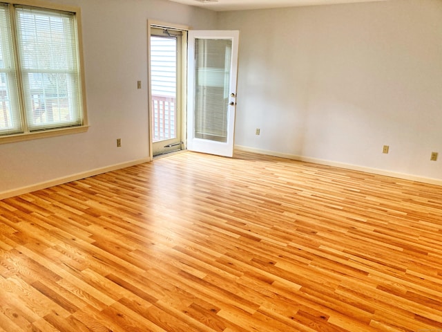 empty room featuring light hardwood / wood-style flooring and a wealth of natural light