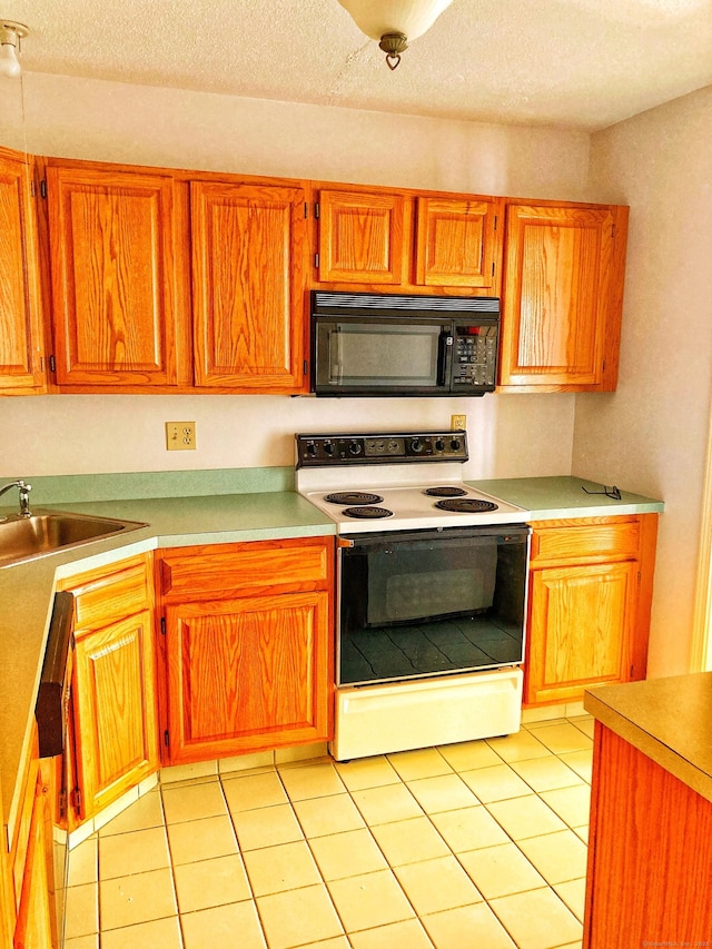 kitchen featuring light tile patterned floors, sink, a textured ceiling, and white electric range oven