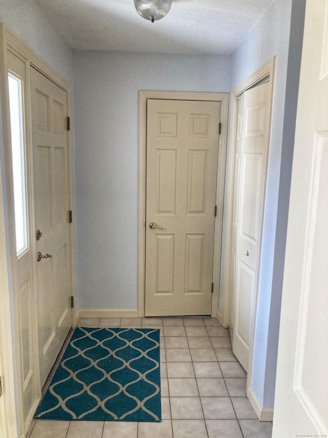 foyer entrance featuring light tile patterned flooring