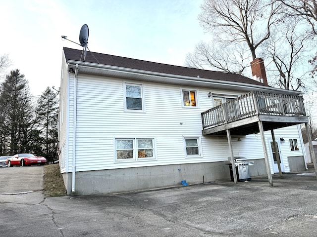 back of property with a wooden deck