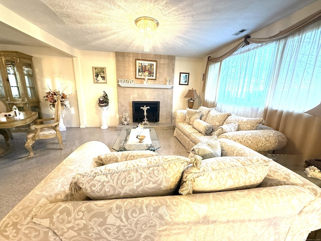 living room featuring a fireplace and a textured ceiling