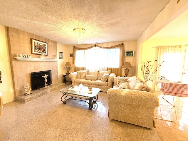 living room with a tiled fireplace and a textured ceiling