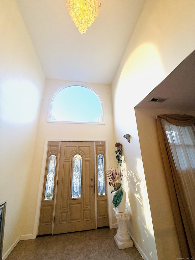 entryway featuring a towering ceiling