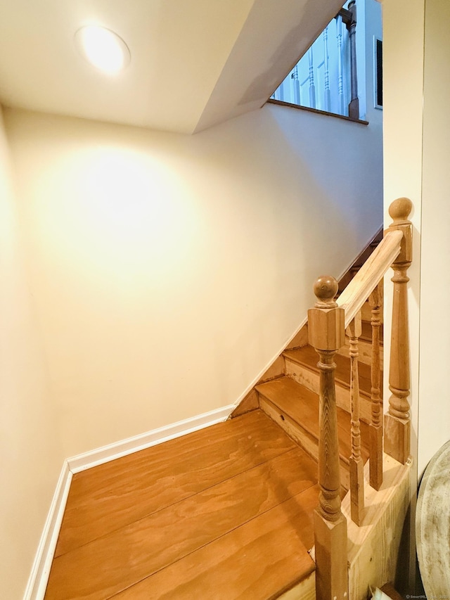 stairs featuring hardwood / wood-style floors