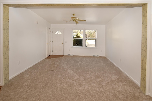 spare room with light colored carpet and ceiling fan