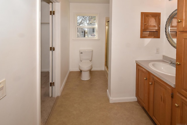 bathroom featuring walk in shower, vanity, and toilet