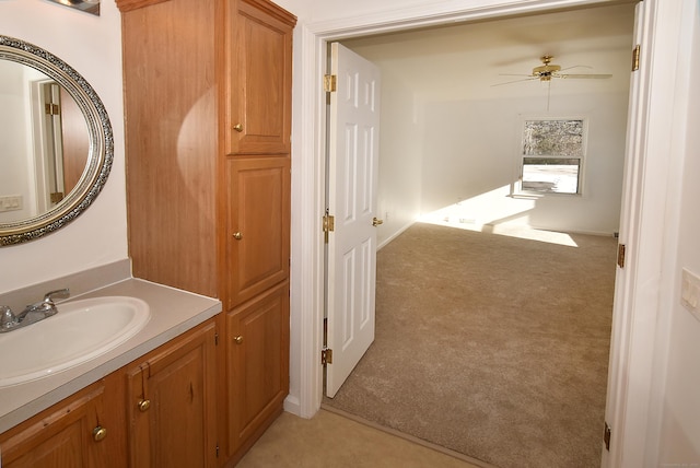 bathroom featuring ceiling fan and vanity