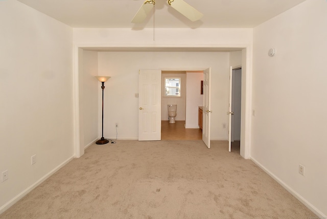 empty room featuring carpet flooring and ceiling fan