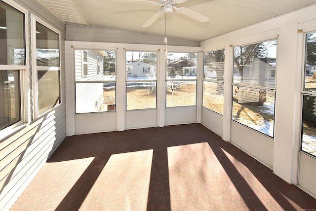 unfurnished sunroom with ceiling fan and lofted ceiling