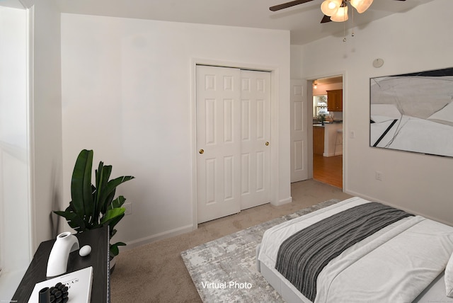 carpeted bedroom with ceiling fan and a closet