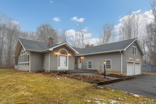 view of front of house with a garage and a front yard