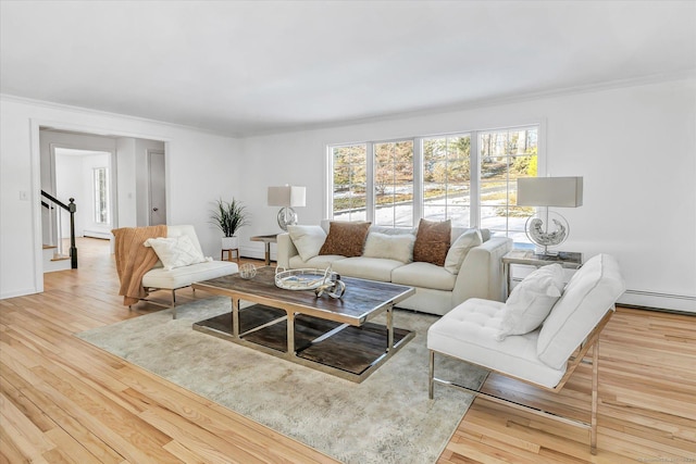 living room with hardwood / wood-style flooring and crown molding