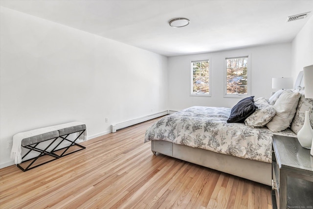 bedroom featuring a baseboard radiator and light wood-type flooring