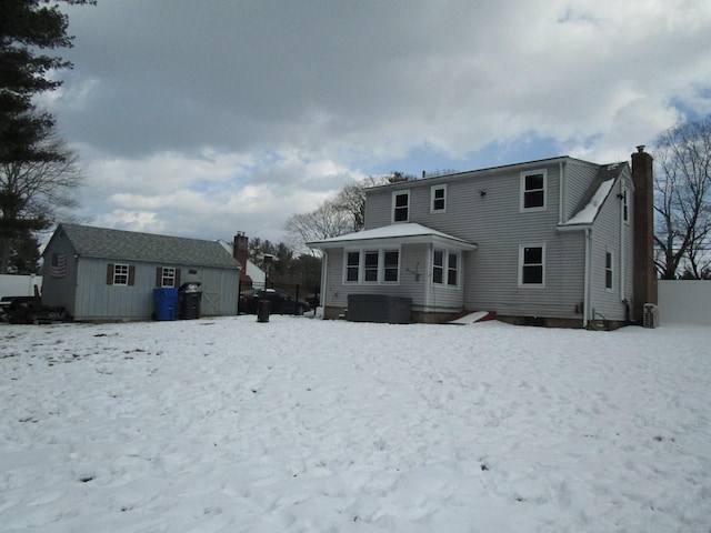 view of snow covered back of property