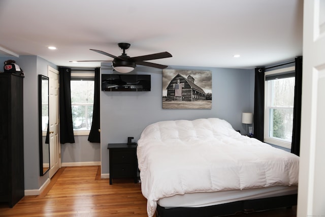 bedroom with ceiling fan and light hardwood / wood-style floors