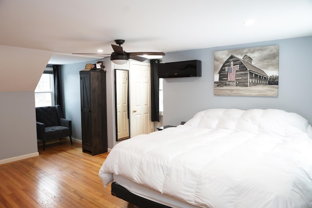 bedroom with hardwood / wood-style flooring and ceiling fan