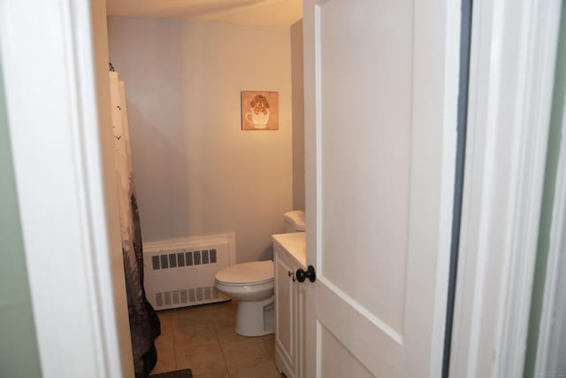 bathroom featuring vanity, toilet, tile patterned floors, and radiator heating unit