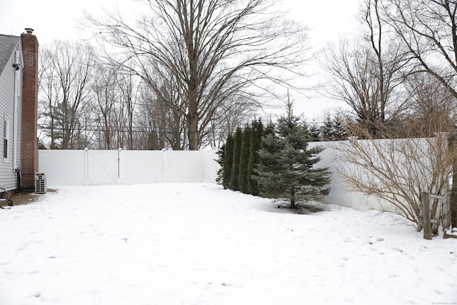 yard covered in snow featuring cooling unit