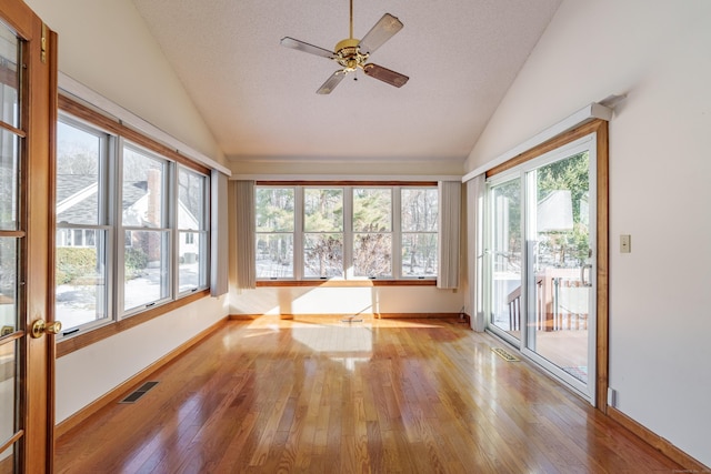 unfurnished sunroom with lofted ceiling, a healthy amount of sunlight, and ceiling fan