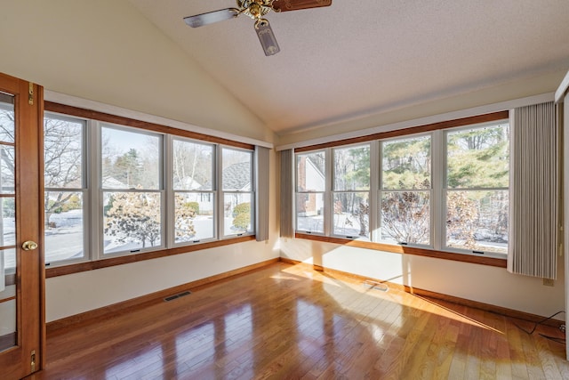 unfurnished sunroom featuring plenty of natural light, lofted ceiling, and ceiling fan