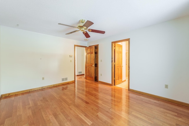 spare room with ceiling fan and light hardwood / wood-style flooring