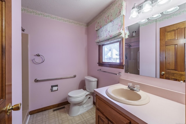 bathroom featuring vanity, toilet, and a shower