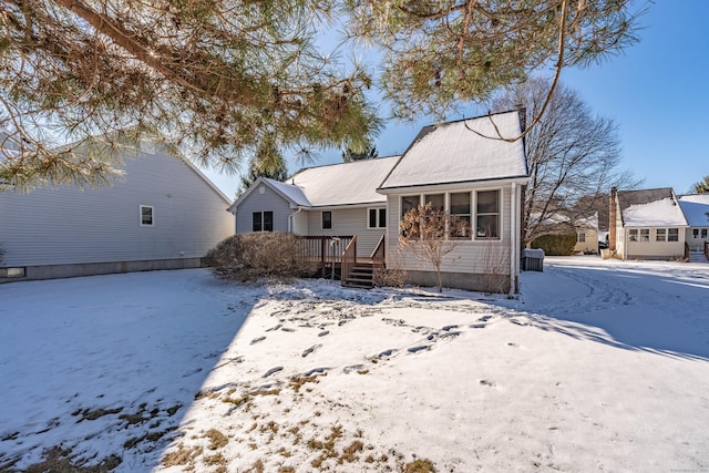 view of front of house featuring a sunroom and a deck